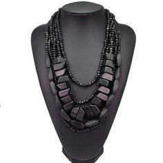 Discover the epitome of earthy elegance with our Bohemian Black Beaded Necklace, meticulously handcrafted to grace your ensemble with a touch of African tribal inspiration. This multi-strand statement piece boasts a harmonious blend of polished wooden elements and lustrous black beads, cascading in layers to create a bold aesthetic that's both timeless and contemporary. Perfectly suited for the fashion-forward individual, this necklace promises to be a versatile addition to your jewelry collecti Penguin Bracelet, Black Necklaces, Crab Earrings, Handmade Statement Necklace, Wooden Bead Necklaces, Beach Necklaces, Bead Necklaces, Wood Bead Necklace, Black Bead Necklace