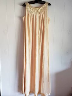 This is a vintage Gossard Artemis nightgown. This piece is sleeveless and is a very pretty shade of pale yellow. There are floral appliques and a satin hem and trim. This piece is labeled a size small, but I think it can fit a larger size than that. There is a small speck and a minor tug in this nightgown. You can see this in the images. The price reflects this. The measurements are as follow: (All measurements taken flat.) Please compare the measurements to your own well fitting clothes as I do Cream Sleeveless Nightgown With Lace Trim, Vintage Sleeveless Nightgown For Bedtime, Vintage Cream Sleeveless Sleepwear, Cream Sleeveless Sleepwear With Lace Trim, Sleeveless Cream Nightgown For Bedtime, Cream Sleeveless Nightgown For Bedtime, Vintage Sleeveless Nightgown For Loungewear, Vintage Sleeveless Cream Nightgown, Vintage Cream Sleeveless Nightgown