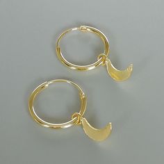 A PAIR of sterling silver hoops dipped in gold. Comes with a tiny crescent moon charm. The charm is multipurpose and can be used with a neck or bracelet chain too. Dimension: Hoop- 12x1 mm Charm- 4 x 9mm Drop length- 18 mm This piece is made of 925 hypoallergenic sterling silver. All my pieces are sent in a gift box. I can include a personal message from you if needed. You are welcome to contact me at... bhavnakwintra1956@gmail.com More hoops: https://www.etsy.com/your/shops/TheSilverGame/tools/ Celestial Huggie Earrings With Moon Charm, Adjustable Moon Charm Hoop Earrings, Adjustable Hoop Earrings With Moon Charm, Celestial Huggie Hoop Earrings For Everyday, Celestial Small Hoop Huggie Earrings, Dainty Huggie Earrings With Moon Charm, Nickel Free Moon Shaped Hoop Earrings Gift, Celestial Small Hoop Huggie Earrings Gift, Huggie Hoop Earrings With Moon Charm For Gift