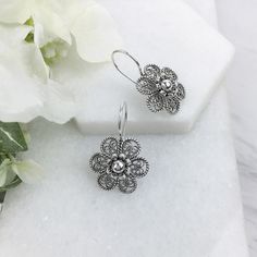 925 Sterling Silver Handmade Artisan Crafted Filigree Flower Earrings Matching necklace is available. https://www.etsy.com/listing/908893204/silver-floral-statement-necklace-925?ref=listings_manager_grid Material: 925 Solid Sterling Silver, 925 Stamped Earrings Length: 1.20 inches Width: 0.75 inches Finishing: Oxidized and Polished Comes with a gift pouch and box Free Domestic Shipping We hope that you enjoy our exclusive artisan handcrafted jewelry. Silver Flower Jewelry With Matching Earrings, Silver Pierced Flower Earrings For Gift, Elegant Silver Flower Pendant Earrings, Hypoallergenic Silver Flower Earrings For Gift, Silver Flower Pendant Jewelry With Matching Earrings, Sterling Silver Flower-shaped Jewelry With Matching Earrings, Silver Drop Flower Earrings Gift, Silver Flower Earrings For Gift, Metal Flower Shaped Jewelry For Anniversary