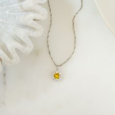 A sunflower necklace can be so uplifting and inspiring. It's bright, yellow gemstone radiates positive energy and life into you! It's such a beautiful pendant, set on a sparkly twisted chain. Whether you're a sunflower jewelry lover or just love flowers or worship the sun, this necklace is made for you! It's a statement piece that can easily work with any outfit - day or night! It also looks great stacked with out necklaces. At Sami Jewels, we believe in making high quality pieces made with love Yellow Round Sunflower Jewelry, Yellow Flower Pendant Necklace With Sunflower Design, Yellow Birthstone Pendant Jewelry, Yellow Birthstone Round Pendant Necklace, Yellow Sunflower Design Flower Pendant Necklace, Dainty Yellow Pendant Jewelry, Spiritual Yellow Jewelry With Birthstone, Dainty Yellow Necklace For Anniversary, Yellow Citrine Round Pendant Necklaces