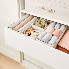 an open drawer with towels and other items in it