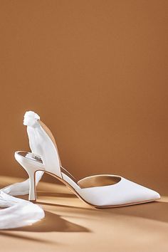 a pair of white shoes sitting on top of a table