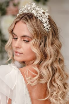 a woman with blonde hair wearing a bridal headpiece