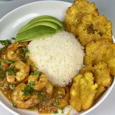 a white plate topped with rice, shrimp and avocado next to fried plantains