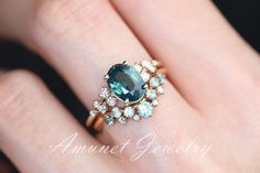 This amazing mermaid sapphire has an unbelievable opaque blue green color, It is a gorgeous looking and the way it sparkles is a complete attention catcher. It's set in a cluster setting with asymmetrical white VS diamonds on either side. The ring also has a matching band whose details are here in this listing: https://www.etsy.com/listing/1039699526/montana-sapphire-ring-sapphire-wedding. It is our recommended band.You can order this ring in 14K yellow, rose or white gold.Main stone: Natural me Mermaid Engagement Ring, Mermaid Sapphire, Sapphire Engagement Ring Unique, Teal Sapphire Ring, Ring Blue Sapphire, Montana Sapphire Ring, Blue Sapphire Engagement Ring, Teal Sapphire, Engagement Ring Unique