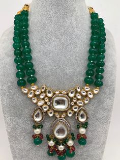 Kundan AD Pendent with Green Beads Necklace with Matching EarringsColor : GoldenSize : Necklace Length : 16 Inches; Earring Length : 2.75 InchesStones : Kundan AD Green Beads Pearls Festive Round Beads Necklace With Stones, Festive Round Bead Stone Necklaces, Festive Beaded Necklaces With Round Stones, Traditional Teardrop Jewelry With Large Beads, Festive Beaded Necklace With Round Stones, Spiritual Green Jewelry With Dangling Beads, Green Spiritual Jewelry With Dangling Beads, Traditional Green Beaded Necklaces With Stones, Traditional Green Beaded Necklace With Stones