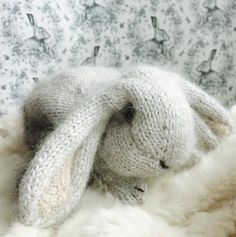 a stuffed rabbit is laying on top of some fur