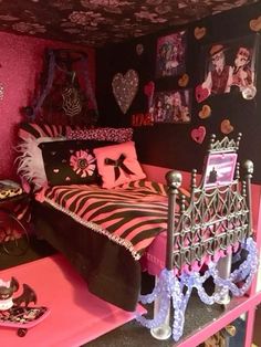 a pink and black bedroom with pictures on the wall, bedding and accessories in it