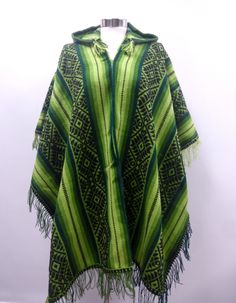 GREEN AND BLACK HOODED SHAMAN AGUAYO PONCHO  This poncho is handwoven in the traditional Andean method "Aguayo" This poncho will fit people's sizes ranging from medium to large.  AGUAYO: This is a naturally dyed blend of alpaca, llama, and sheep wool, handwoven in the Andean village of Peru. Measurement: 70 X 46 inches Country:  Perú  Culture: Quechua   Material: Alpacryl ( Alpaca and acrylic) Green Hooded Poncho For Winter, Green Hooded Winter Poncho, Winter Green Hooded Poncho, Traditional One Size Hooded Poncho, Peru Culture, Poncho Design, Hooded Poncho, Men Wear, Wearing A Hat