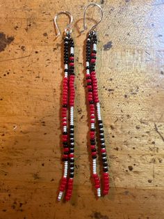 Black, Red, and White Tassel Seed Bead Shoulder Duster Earrings. Hang 4 inches from hand made copper ear wires. Adjustable Red Beaded Earrings With Black Beads, Traditional Red Earrings With Black Beads, Red And Black Beaded Drop Earrings, Red Beaded Earrings With Black Round Beads, Black Beaded Earrings, Earring Inspo, Shoulder Duster Earrings, Duster Earrings, Branch Earrings