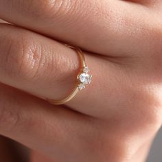 a woman's hand with a diamond ring on it