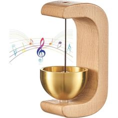 a golden singing bowl on a wooden stand with musical notes coming out of the top