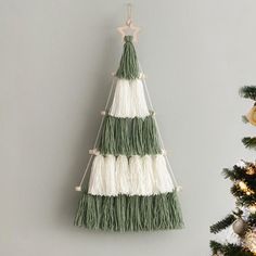 a green and white christmas tree hanging on the wall