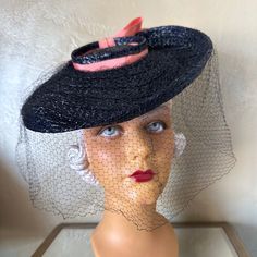 What A Fantastic Look From The Fashionable 1940s'! This Beautiful Hat Is Made Of Navy Straw. The Crown Is Very Small And Round, Surrounded By A Wide Brim.Under The Brim There Is A Half Cap Towards The Back To Hold The Hat In A Tilted Position. The Crown Is Trimmed With A Pink Grosgrain Band Which Ends In A Bow At The Back. To Finish This Look, There Is A Full Black Veil. The Wartime 40’s Saw A Huge Variety Of Hats That Were Suitable For Any Face Shape, Hairstyle Or Personal Preference. Throughout The War & On Both Sides Of The Atlantic, Elaborate Creations Brightened Dreary Utility Fashions, Brought About By Rationing. The Only Items Not Rationed Were Hat Materials. Explosions Of Feather Royal Ascot, Black Veil, Beautiful Hats, Wide Brimmed Hats, The Atlantic, Brim Hat, Face Shape, Fashion History, Wide Brimmed