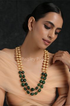 The double-layered pearl necklace is inspired by the rich Indian jewelry-making techniques handcrafted by artisans to celebrate the amalgamation of craftsmanship and modern design. The gold plated stone necklace with jade green stones is a most elegant and perfectly crafted necklace to bejewel your neckline that will create a style statement wherever you go. Pair this gorgeous replica of western jewelry with your ethnic or contemporary ensembles and create a look to remember. Necklace Closure - Western Pearl Necklace, Temple Jewelry Necklace With Pearl Drop And Round Beads, Festive Pearl Drop Necklace With Round Beads, Double Strand Pearl Chain Beaded Necklace Gift, Double Strand Pearl Beaded Necklace For Gift, Festive Pearl Necklace With Round Beads Pendant, Gift Double Strand Beaded Necklace With Pearl Pendant, Double Strand Beaded Necklace With Pearl Pendant As Gift, Temple Style Pearl Necklace With Round Beads