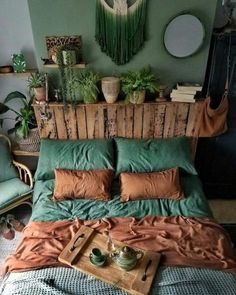 a bed that has some plants on top of it and a tray with tea cups