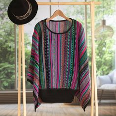 A soft and exotic piece of clothing, this pullover sweater is presented by Alfredo Falcon of Peru. An attractive boat neck and loose, flowing sleeves add fashionable details to the design. Knit from a soft blend of acrylic and baby alpaca, the sweater is adorned with a festive striped pattern in shades of purple, pink, green, and blue. Striped Kimono, Design Knit, Flowing Sleeves, Striped Pullover, Kimono Sleeve, Baby Alpaca, Fall Looks, Sweater Sleeves, Shades Of Purple