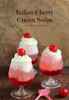 three glasses filled with ice cream and cherries on top of a wooden table next to a