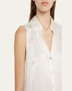 L'Agence "Emmy" lustrous blouse finished with tonal buttons     Spread collar; button front    Sleeveless    Yoked back    Relaxed fit    Shirttail hem    Silk    Dry clean    Imported Sleeveless Workwear Top With Back Button Closure, Chic Sleeveless Top With Back Button Closure, Sleeveless Tops For Work With Back Button Closure, Elegant Sleeveless Top With Back Button Closure, Elegant Summer Top With Button Back, Elegant Button Back Summer Tops, Elegant Summer Tops With Button Back, Elegant Workwear Tank Top With Button Closure, Elegant Tank Top With Button Closure For Work