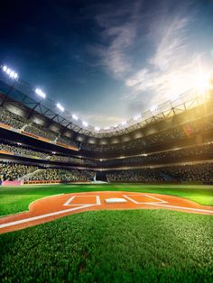 an empty baseball stadium filled with lots of people and lights on the side of the field