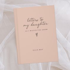 a pink book with the words letters to my daughter as i watch you grow on it