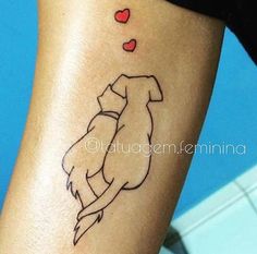 a woman's leg with a tattoo on it that has two dogs hugging each other