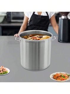 a woman holding a large pot on top of a table