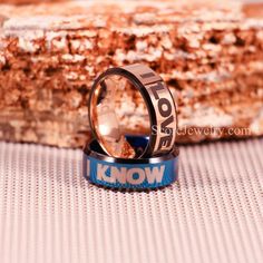 a ring with the words know on it sitting next to a piece of bread that has been cut in half