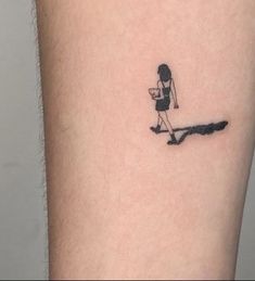 a woman walking with a cat tattoo on her leg