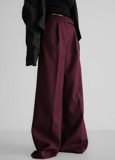 Color: Burgundy Midweight woven fabric Regular fit Wide leg Mid-rise Belt loops Side seam pockets Back illusion welt pockets Zip fly Asymmetric front button closure Unlined 77% Polyester 21% Rayon 2% Elastane Dry Clean By The Frankie Shop. Imported Baggy Wide-leg Dress Pants For Workwear, Baggy Full-length Bottoms For Workwear, Tailored Wide Leg Full-length Pants With Pockets, Baggy Wide-leg Pants For Work, Tailored Full Length Wide Leg Pants With Pockets, Baggy Formal Pants For Fall, Baggy Wide-leg Pants With Welt Pockets, Baggy High-waisted Wide Leg Pants For Work, Formal Baggy Wide-leg Pants