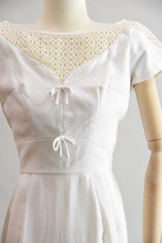 "Vintage 1950 cocktail wiggle dress. White linen with v shaped illusion neckline with scroll embroidery on top both in front and back and partially on sleeves. Two decorative bows under bust for detail. Darted bust, capped sleeves, and fitted waist. Straight skirt with kick pleat in back. Rear metal zip closure. State of garment | very good, light overall wear. Measurements ✂--- best fit | Extra Small bust | up to 35\" shoulders | not specified shoulder to waist | 15.5\" sleeves | about 4.5\" wa Rehearsal Dinner Dress, Church Fits, Rehearsal Dinner Dresses, Vintage Details, Decorative Bows, Illusion Neckline, Kick Pleat, Different Dresses, Capped Sleeves