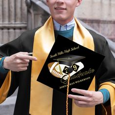 a man in a graduation gown holding up his diploma