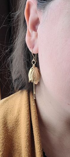 I thought to add a different flower to my store bouquet. Wondering in my favorite bead store, I found these unique gold plated brass tulip flower tops. Boy, was I in love! The free movement of the pollen dangles add an elegant touch. The hooks are hand hammered 14K gold plated over brass. I wear a pair when I go out on a date, to a wedding or even the opera.  Bridesmaids would be delighted to get a pair as a gift. They look great with any color and especially floral patterns. Free Movement, Tulip Flower, Bead Store, Flower Tops, The Opera, Different Flowers, Tulips Flowers, Gold Flower, Earrings Photo