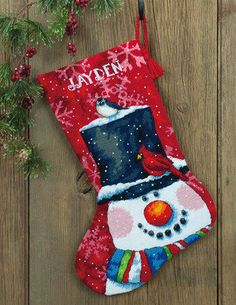 a christmas stocking with a cardinal on it and the name jayden printed on it