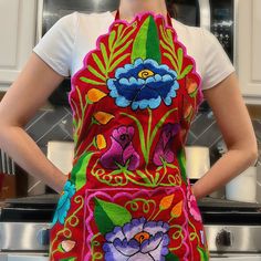 a woman wearing an apron with flowers on it