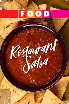 a bowl filled with salsa surrounded by tortilla chips