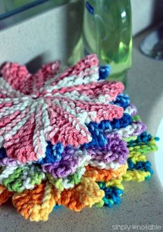 a pile of crocheted dishcloths sitting on top of a sink