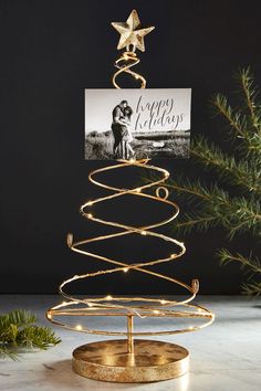 a christmas tree with lights and a card on top