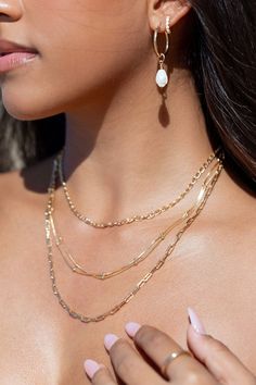 A classic shimmery gold box chain dotted with luminous spheres. This elegant gold chain is a stunning addition to your collection. A striking delicate statement worn alone or with a bevy of other beauties. ✦ DETAILS ✦ ✧ Name: Kahiwa - (kah EE vah) - my favorite. ✧ 1mm chain with 2mm spheres. ✧ 18kt gold filled chain and spring clasp. ✧ You will receive 1 necklace. Other necklaces sold separately. ✧ All Ke Aloha Jewelry pieces come packaged thoughtfully, beautifully, and ready for gift giving. ✧ Gold Layered Necklace With Pearl Chain For Party, Pearl Chain Metal Layered Necklace For Gift, Metal Layered Necklace With Pearl Chain For Gift, Layered Metal Necklace With Pearl Chain For Gift, Gold Snake Chain Layered Necklace Gift, Elegant Jewelry With Box Chain And Round Beads, 14k Gold Filled Pearl Chain Necklace, 14k Gold-filled Box Chain Necklace, Gold Plated Snake Chain Layered Necklace