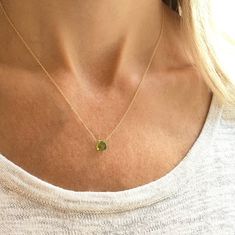 This genuine peridot gemstone sits on a dainty gold filled, sterling silver, rose gold filled or 14k gold chain. Subtle and simple, this beautiful semi-precious stone necklace is perfect by itself or for layering with other necklaces. Peridot is the birthstone for August. The length on the model is 16 inches. Jewelry is handmade by us in our NYC studio. We focus on craftsmanship and quality using only the highest quality materials and handpicked genuine gemstones.  PACKAGING We take pride in cre Dainty Yellow Gold Charm Necklace For May Birthstone, Dainty Yellow Gold Charm Necklace With May Birthstone, Dainty Yellow Gold Charm Necklace With Emerald, Faceted Yellow Gold Necklaces For May Birthstone, Dainty 14k Gold Charm Necklace For May Birthstone, Yellow Gold Dainty Necklace For May Birthstone, Dainty 14k Gold May Birthstone Charm Necklace, Delicate May Birthstone Round Pendant, Dainty Round Necklace For May Birthstone