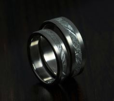 two wedding bands with black and white marble inlays