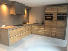 an empty kitchen with wooden cabinets and counter tops