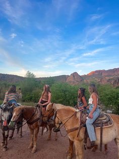 several people are riding horses in the desert