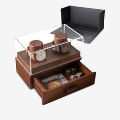 an open drawer with watch and other items in it