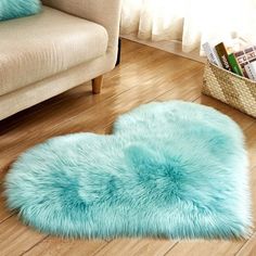 a blue heart shaped rug sitting on top of a wooden floor