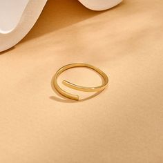 Introducing our Minimalist Bypass Ring, a sleek and understated addition to your jewelry collection. This ring features a plain design that embodies minimalist elegance. Its bypass style allows for effortless stacking with other rings, offering versatility and customization to your look. Elevate your style with this timeless and versatile accessory that exudes simplicity and sophistication. - Made in 14k solid gold - Band Width: 1.42 mm / 0.05 inches - Thickness: 1.06 mm / 0.04 inches -This prod Minimalist Adjustable Open Band Ring, Minimalist Adjustable Bypass Ring, Gold Minimalist Stackable Bypass Ring, Minimalist Gold Stackable Bypass Ring, Minimalist Stackable Open Rings For Everyday, Adjustable Open Ring Minimalist Style, Minimalist Everyday Stackable Open Rings, Everyday Minimalist Stackable Open Rings, Minimalist Stackable Bypass Ring With Open Band