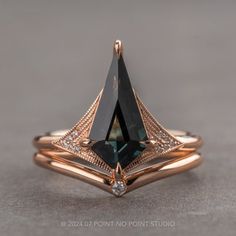 a rose gold ring with a black diamond