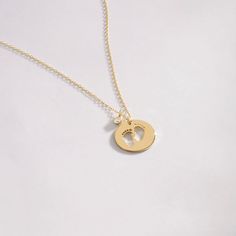 "Our 14k Solid Gold Baby Footprint necklace has been designed with a mother's warm touch in mind. The high-quality dainty diamond necklace that'll keep the memory of motherhood alive. The perfect gift for a perfect mom on Mother's day or a birthday. F E A T U R E S * Made to Order. * Gold KT: 14K * Choice of Gold Color: Yellow Gold, Rose Gold, White Gold * Gem Stone: Genuine Diamond * Diamond-Cut: Round * Diamond Carat: 0.01 ct * Pendant Height: 12 mm / 0.47 inch * Pendant Width: 12 mm / 0.47 in Personalized Yellow Gold Charm Necklace In Recycled Gold, Minimalist Gold Jewelry For Keepsake, Minimalist Gold Jewelry As Keepsake, Yellow Gold Birthstone Jewelry For Keepsake, Keepsake Yellow Gold Jewelry With Birthstone, Yellow Gold Round Keepsake Jewelry, Hypoallergenic Gold Necklaces For Keepsake, Hypoallergenic Gold Necklace For Keepsake, Personalized Yellow Gold Charm Necklace Fine Jewelry