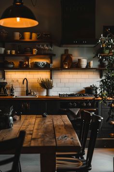 a wooden table sitting under a light in a kitchen